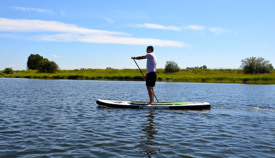 paddling the current drives huey inflatable sup