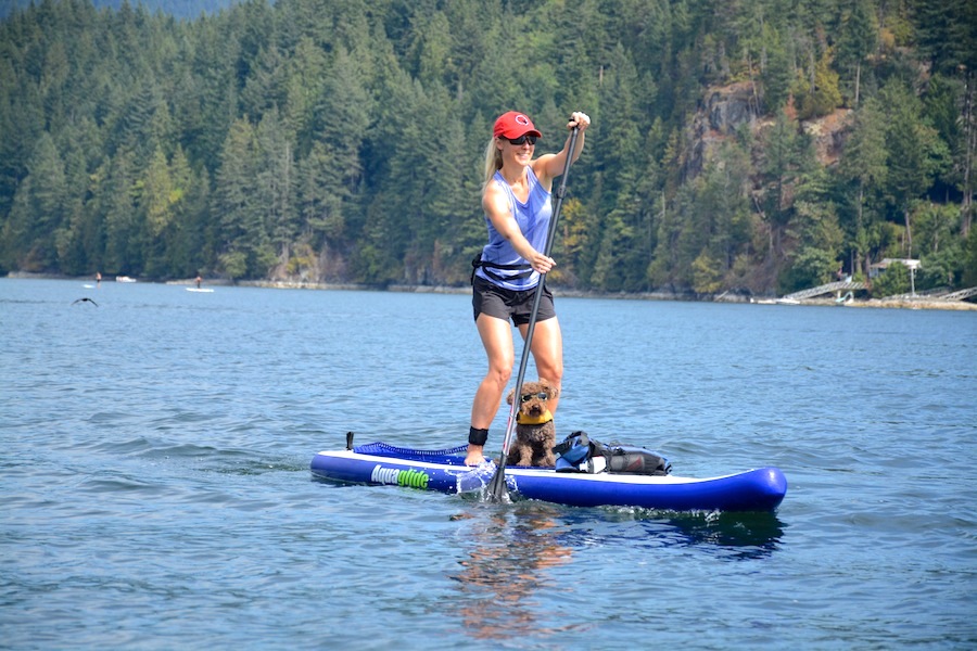 stand up paddling with dog wearing Doggles