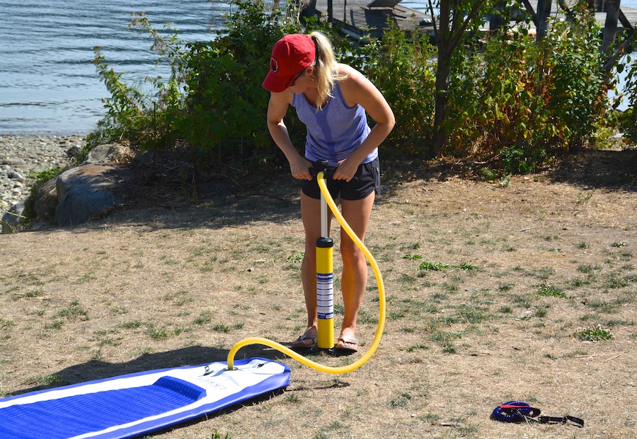 using hand pump to inflate inflatable stand-up paddleboard