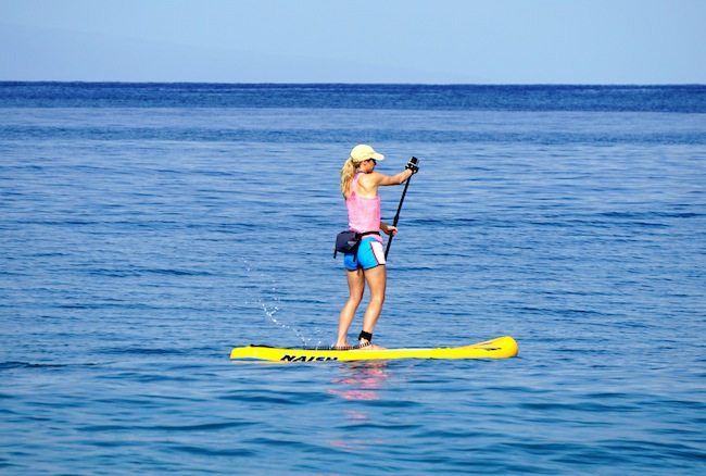 stand-up paddling wearing the Chums Downriver Rolltop bag