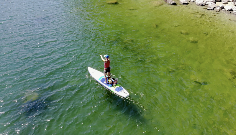 Hero SUP Dynamo touring inflatable paddle board paddling on green water