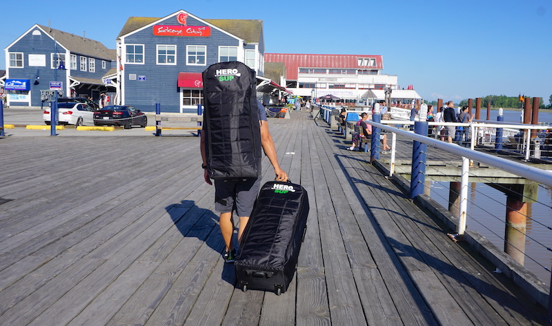 Rolling the Hero SUP paddle board in backpack