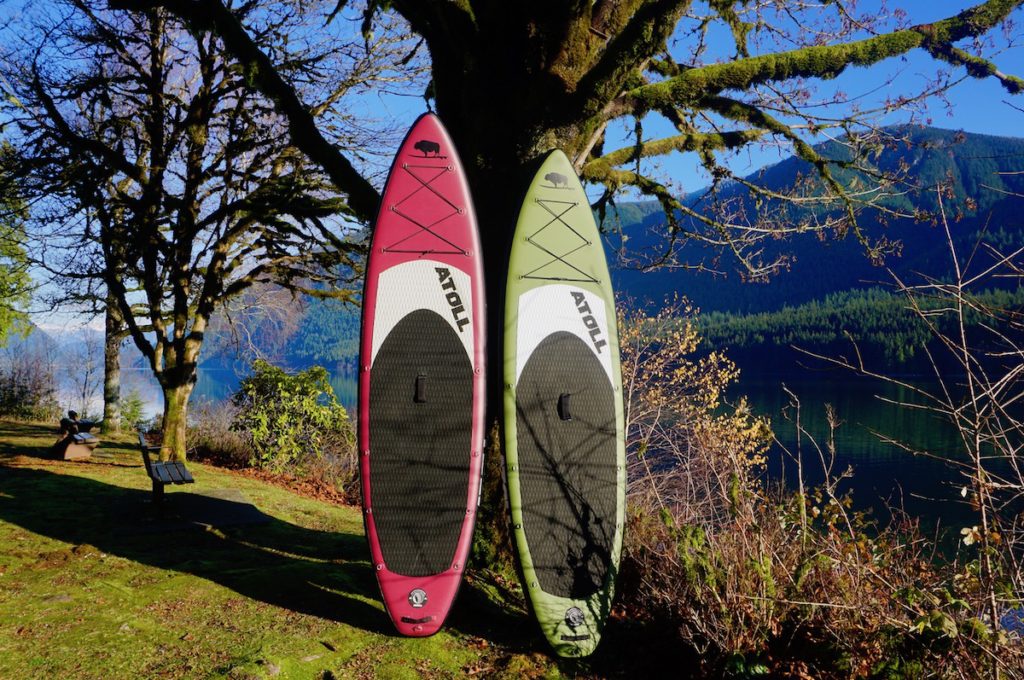 red and army green atoll inflatable stand up paddle boards side by side
