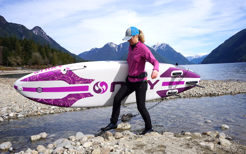 carrying the purple Newport G4 inflatable SUP